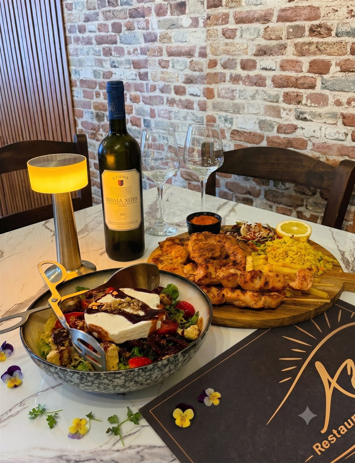 Table set with wine and grilled specialties at Aigli